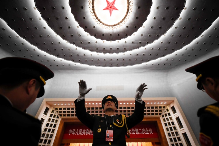 A Chinese People's Liberation Army (PLA) officer practices conducting a military band in Beijing.
