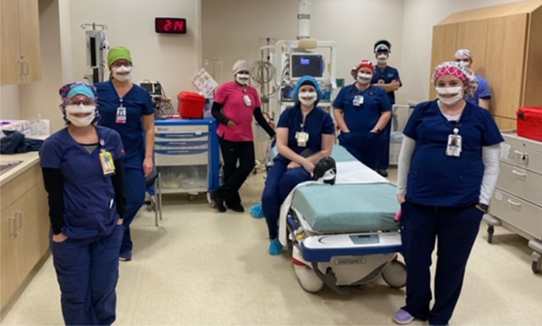 Image: The emergency department night shift at the Nanticoke Memorial Hospital in Seaford, Del., wear partially transparent masks.