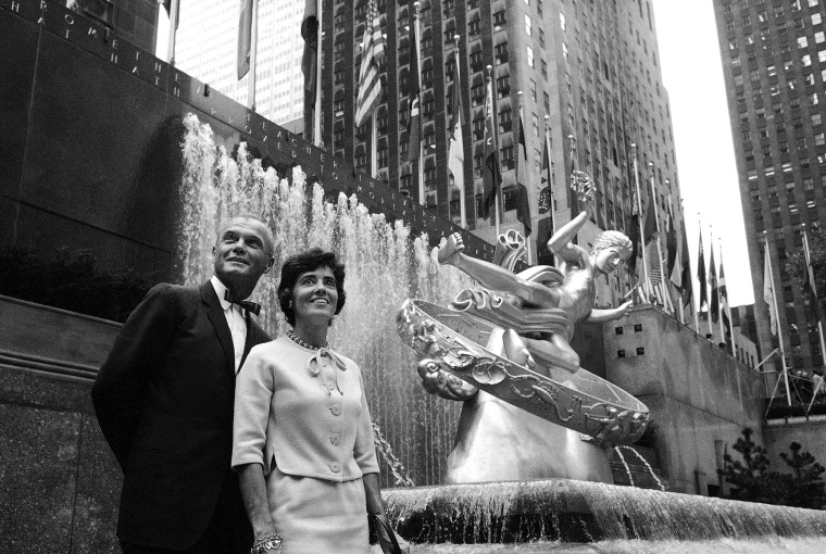Lt. Col. John H. Glenn Jr., first American to orbit the earth, and his wife Annie, look over the sights at Rockefeller Plaza, from alongside the statue of Prometheus, in New York, Sept. 19, 1963.