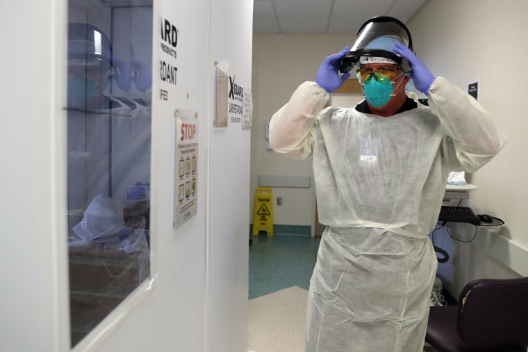 Image: Respiratory therapist Casey White prepares to attend to a patient suffering from the coronavirus disease (COVID-19) in the Intensive Care Unit (ICU), at Scripps Mercy Hospital in Chula Vista