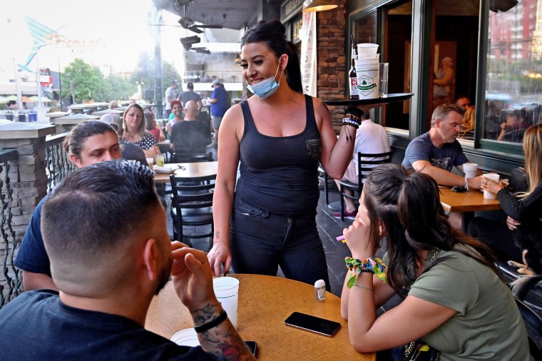 Server Timi Sanchez waits on customers at Hennessey's Tavern as restaurants are opening for business on sidewalks in Las Vegas on May 15.