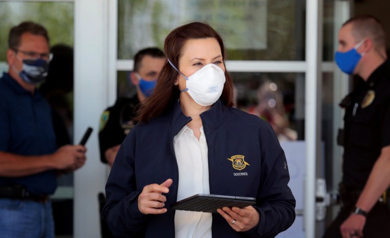 Image: Michigan Governor Gretchen Whitmer arrives for a press conference after several dams breached in Midland on May 20, 2020.