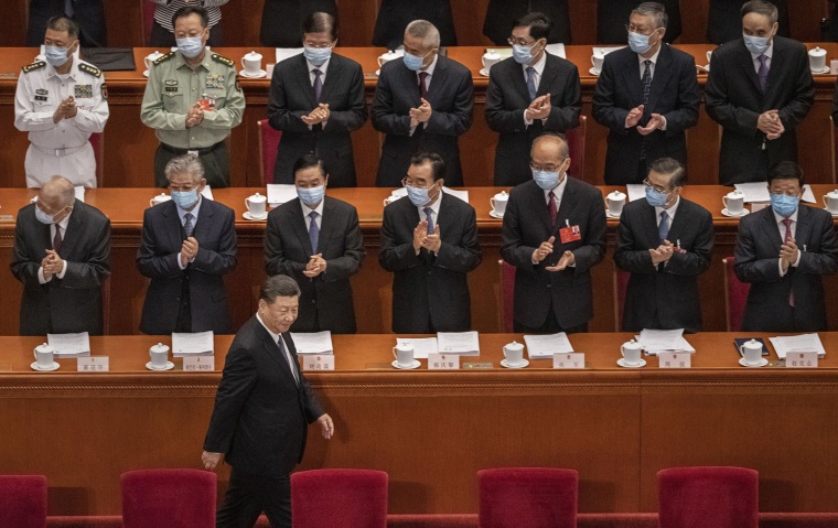 Image: Chinese president Xi Jinping is applauded by delegates wearing protective masks as he arrives at the opening of the National People's Congress