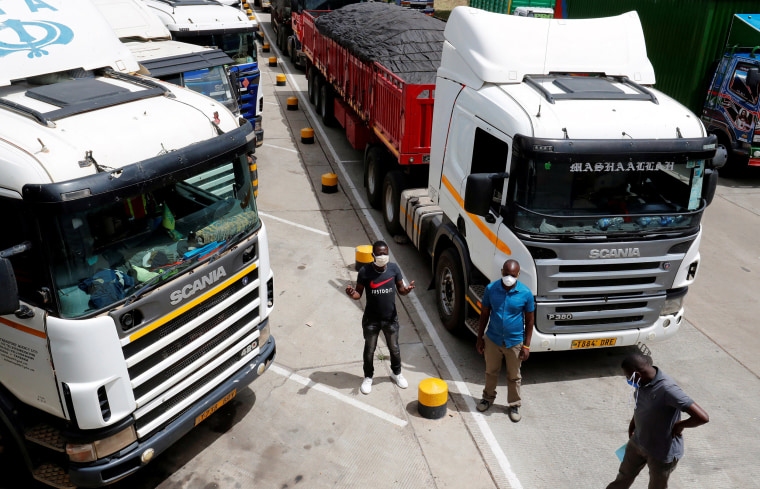 Image: Truck drivers are seen near their parked vehicles as they await test results, amid the spread of the coronavirus disease (COVID-19) outbreak at the Namanga one stop border crossing point between Kenya and Tanzania in Namanga, Keny