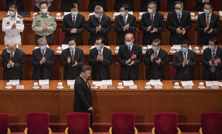 Image: Chinese president Xi Jinping is applauded by delegates wearing protective masks as he arrives at the opening of the National People's Congress on May 22, 2020 in Beijin