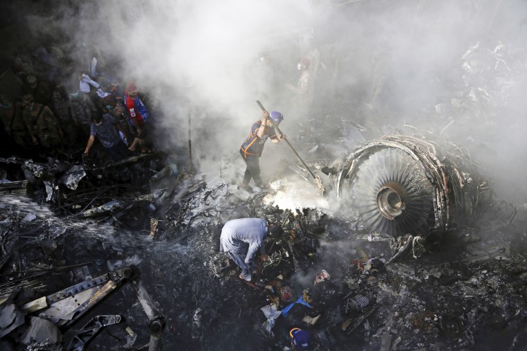 Volunteers look for survivors after a plane crashed in a residential area of Karachi, Pakistan, on May 22, 2020.