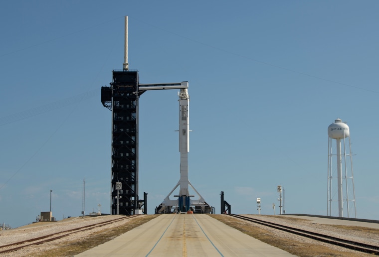 A SpaceX Falcon 9 rocket with the company's Crew Dragon spacecraft onboard is raised into a vertical position on the launch pad at Launch Complex 39A as preparations continue for the Demo-2 mission on May 21, 2020, at NASA's Kennedy Space Center in Florida.