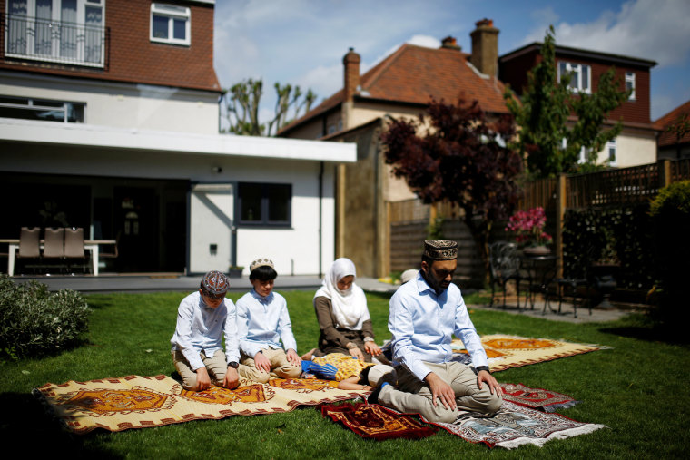 Image: Farood Ahmed and his wife, Sana, pray with their children Zaine, Rayan, Usman and Inaya in their garden to mark the end of Ramadan in Surbiton, London, on May 24, 2020.