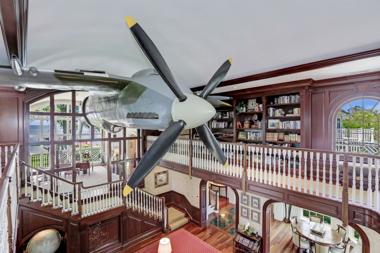 A second home owned by the same owner, also for sale, features a real plane hanging from the living room ceiling. 