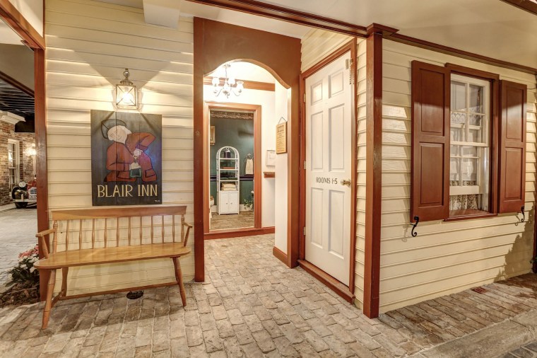 The basement also includes a fully-functioning bathroom disguised as a quaint inn. 