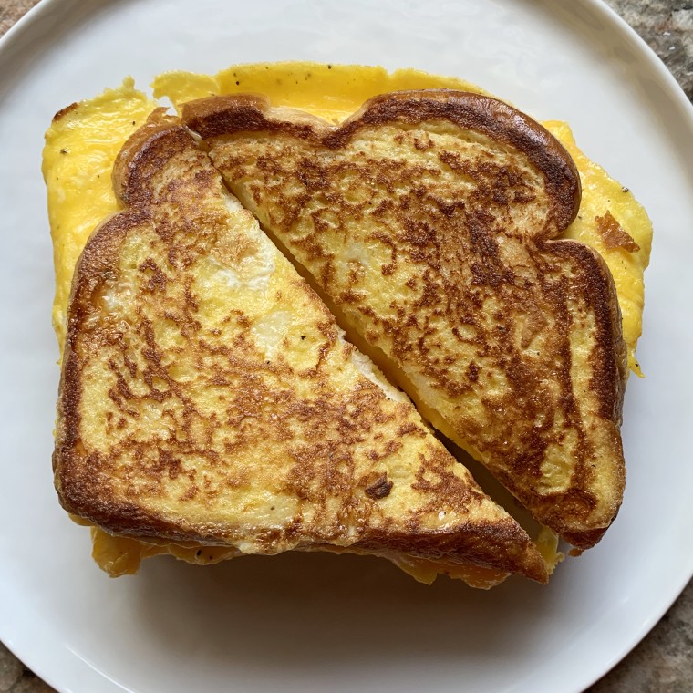 Close the sandwich and continue to cook until the cheese has melted and the bread has begun to brown, then cut it down the middle and serve!