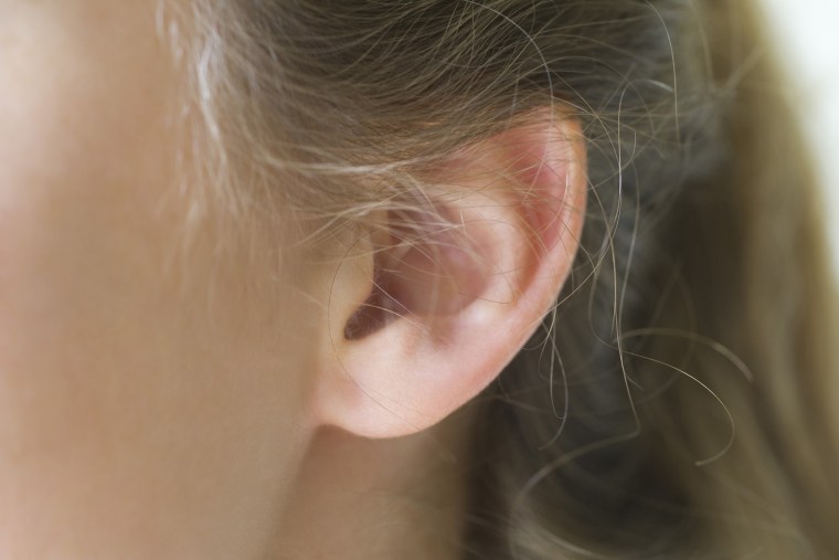 Close-up of young woman's pierced ear