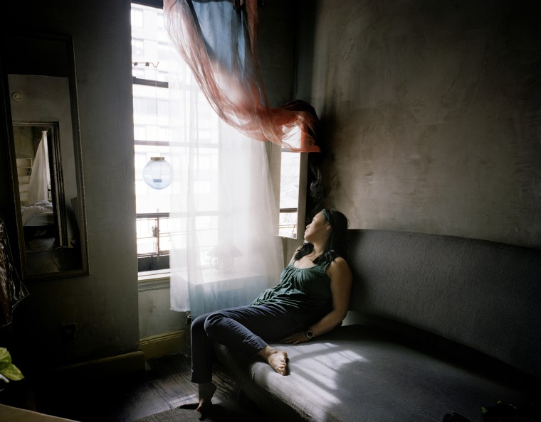 USA, New York State, New York City, Woman looking through window