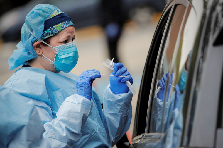 Image: Nurses work at a drive-thru testing site for the coronavirus disease (COVID-19) at North Shore University Hospital in Manhasset, New York