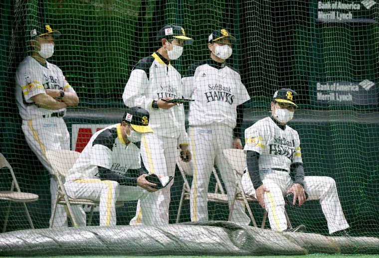 Image: Fukuoka SoftBank Hawks coaches wear face masks during an intrasquad game in Japan on May 25, 2020.