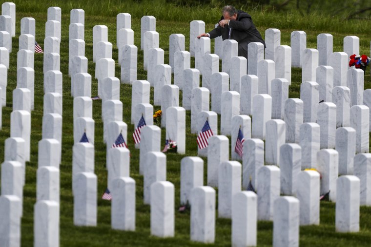 Image: Raymond Piacquadio kneels at his mother's grave at the Cemetery of the Alleghenies, a Veterans Administration National Cemetery, in Bridgeville, Pa., on May 23.