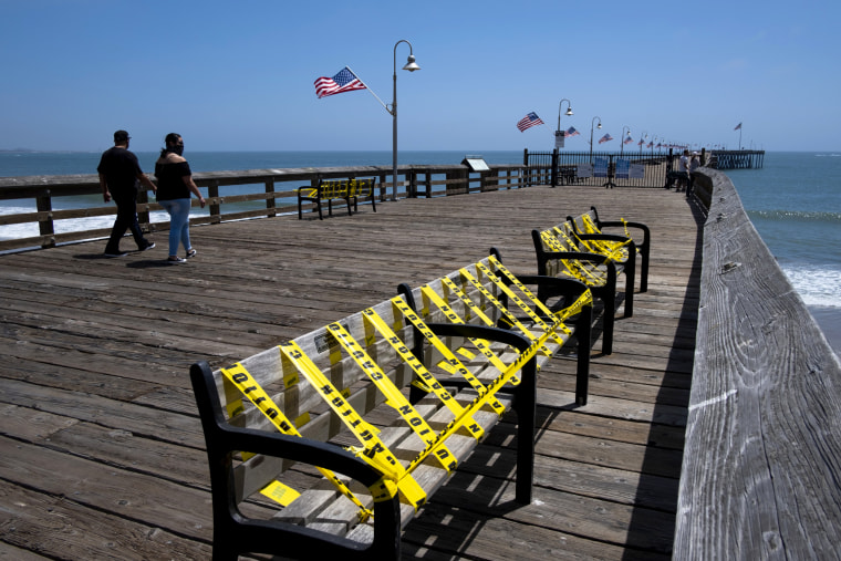 Image: Benches are blocked with caution tape near the beachfront in Ventura, Calif., on May 24.