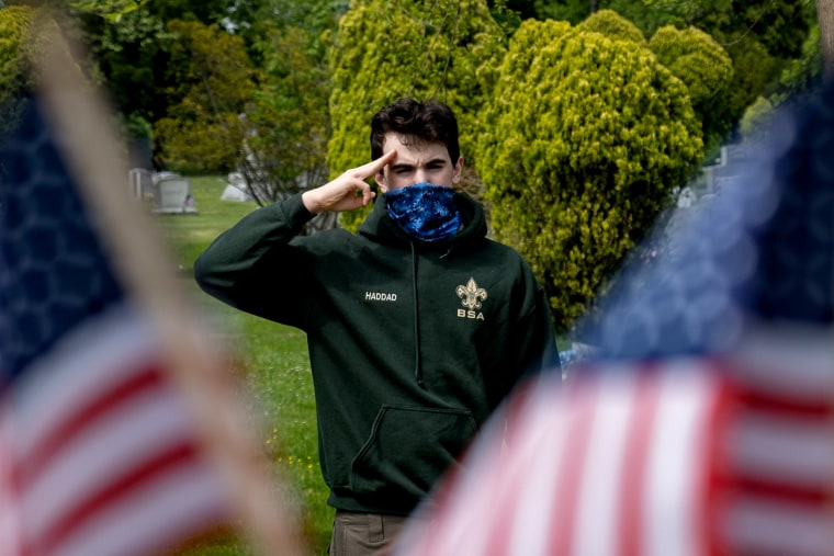 Image: A member of the Boy Scouts of America salutes at a ceremony for veterans in Staten Island, N.Y., on May 25, 2020.