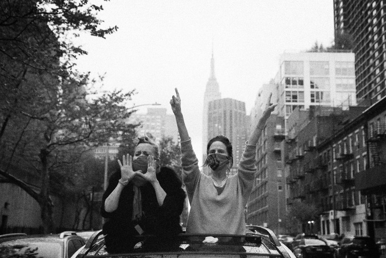 Image: People cheer for health care workers outside of NYU Langone Health on National Nurse Day in New York on May 6, 2020.