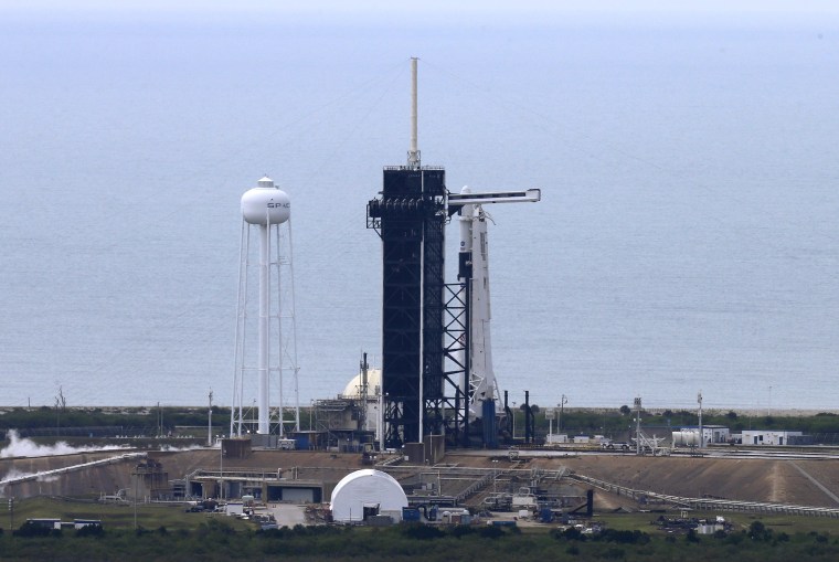 Image: A SpaceX Falcon 9 rocket and Crew Dragon spacecraft carrying NASA astronauts Douglas Hurley and Robert Behnken is seen before scheduled launch from NASA's Kennedy Space Center in Cape Canaveral