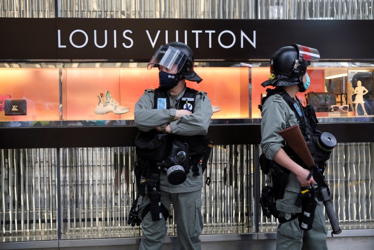 A security staff stands guard in front of a boutique of Louis