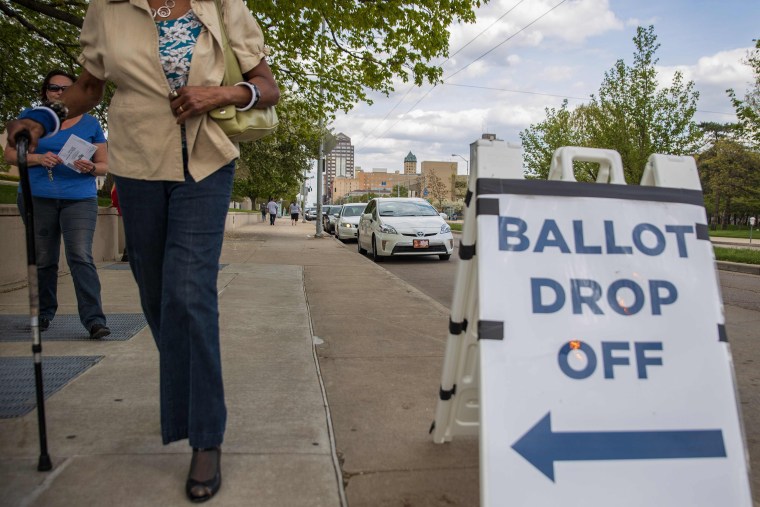 Image: Ohio voters walk to drop off their ballots at the Board of Elections in Dayton, Ohio