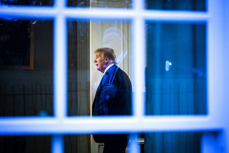 Image: President Donald Trump watches a television inside a press office at the White House on April 22, 2020.