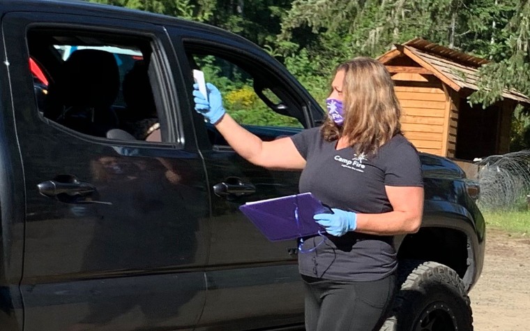 Camp Fire Wilani executive director Elissa Kobrin checks every camper's temperature upon arrival each morning with a no-touch thermometer.