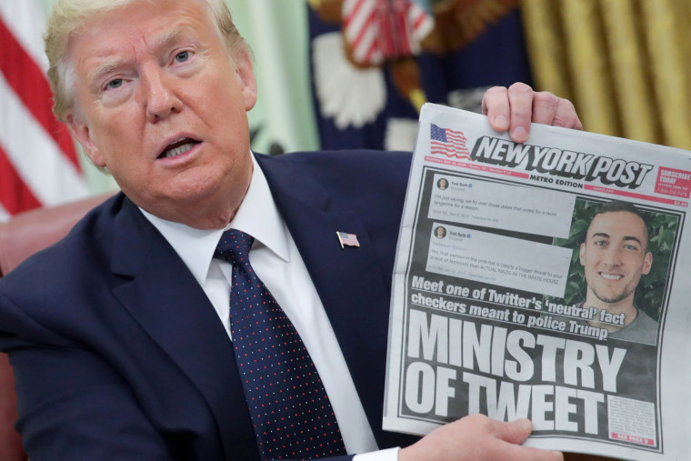 Image: President Donald Trump holds up a front page of the New York Post as he speaks to reporters while discussing an executive order on social media companies in the Oval Office