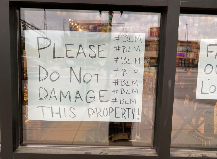 A sign in a window in St. Paul, Minn., expresses solidarity with the Black Lives Matter movement as it asks to looters to spare the store.