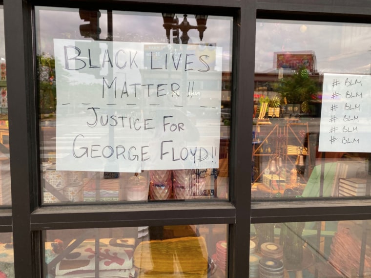 A sign in a store window in St. Paul, Minn., expresses solidarity with the Black Lives Matter movement as it asks to looters to spare the property.