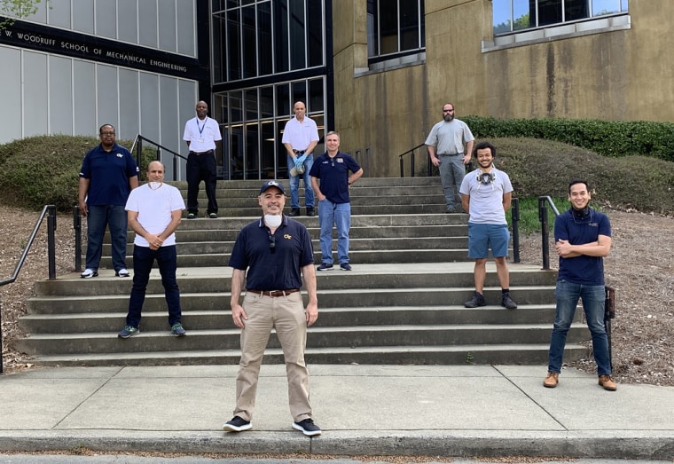 Craig and Saldana (far right) pose with Georgia Tech's president and faculty in front of the George W. Woodruff School of Mechanical Engineering after receiving a donation from Coca-Cola for 6,000 pounds of plastic to produce face shields.