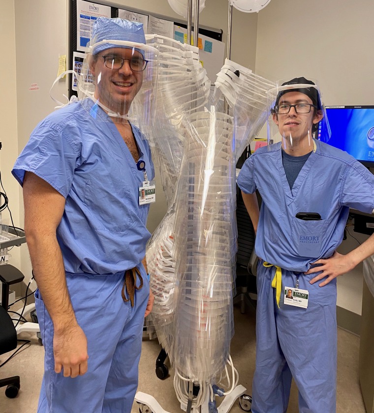 Dr. Devin Weinberg (left) and Dr. Sean Kelly (right), assistant professors of anesthesia at Emory University Hospital, pose with their first delivery of face shields from Georgia Tech.