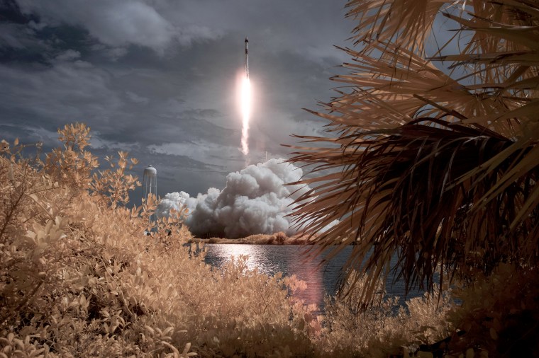 Image: A SpaceX Falcon 9 rocket carrying the Crew Dragon spacecraft launches from NASA's Kennedy Space Center in Cape Canaveral, Fla., in this false color infrared exposure photo on May 30, 2020.