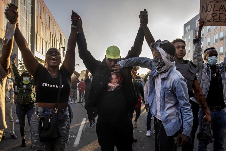 Image: A demonstrator wipes a tear from a fellow demonstrator's face during a clash with police officers as they protest the death of George Floyd and police brutality, in Minneapolis, Minn., on Friday, May 29, 2020. (Victor J. Blue/The New York Times)