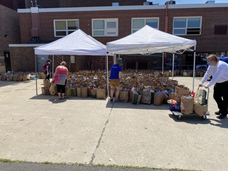 Volunteers help sort food donations outside of Sanford Middle School.
