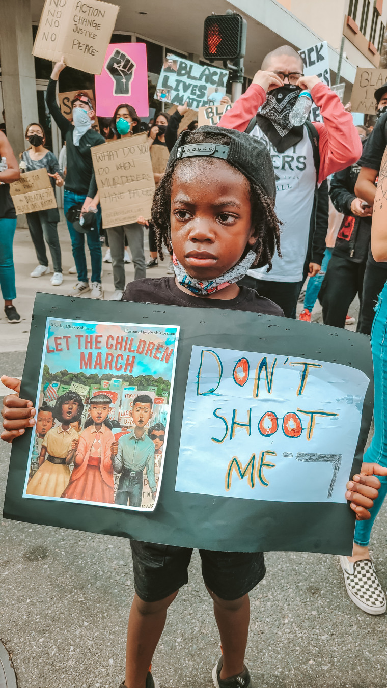 Aiden made his own sign for the protest, writing, "Don't shoot me," after telling his mom he didn't want to be shot like Ahmaud Arbery, a 25-year-old black man who was killed by armed white residents of a Georgia neighborhood in February 2020.