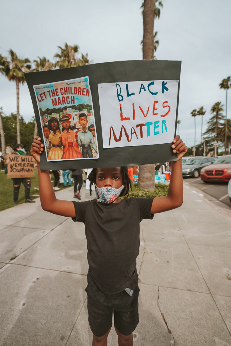 On the opposite side of Aiden's protest sign, the 7-year-old wrote, "Black lives matter."