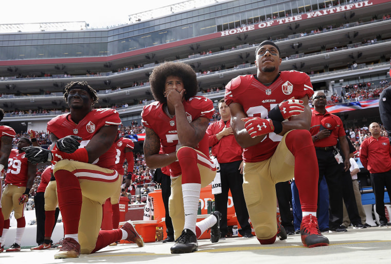 Image: San Francisco 49ers outside linebacker Eli Harold, left, quarterback Colin Kaepernick, center, and safety Eric Reid kneel during the national anthem before an NFL football game against the Dallas Cowboys in Santa Clara, Calif