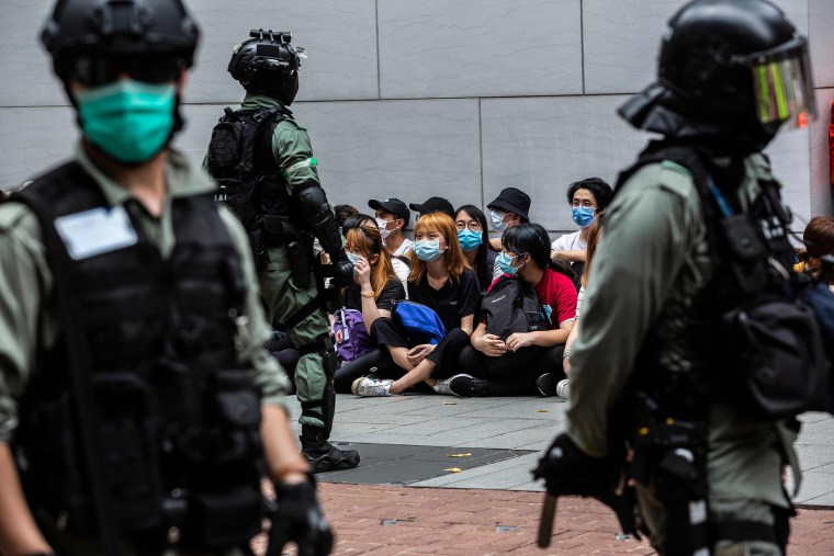 Image: Riot police detain a group of people during a protest in the Causeway Bay district of Hong Kong