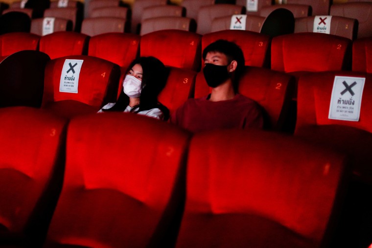 Image: People wearing protective face masks are seen inside a movie theater during its reopening after the Thai government eased isolation measures to prevent the spread of the coronavirus disease (COVID-19) in Bangkok, Thailand
