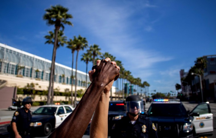 Image: People hold hands in solidarity during a protest demanding justice in the death of George Floyd in Long Beach, Calif., on May 31, 2020.