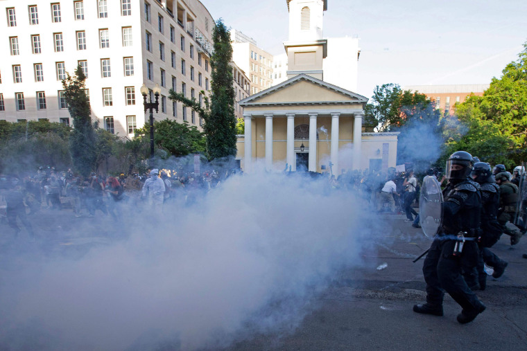 Image: Police officers wearing riot gear push back demonstrators shooting tear gas next to St. John's Episcopal Church  outside of the White House