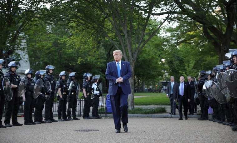 Image: President Donald Trump walks between lines of riot police in Lafayette Park across from the White House after walking to St John's Church for a photo opportunity