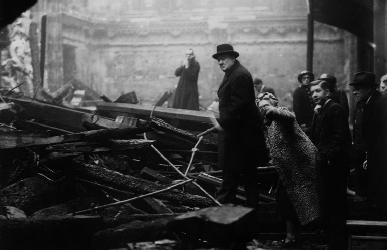 Image: British Prime Minister Winston Churchill and his wife inspect bomb-damage in the City of London during the Blitz