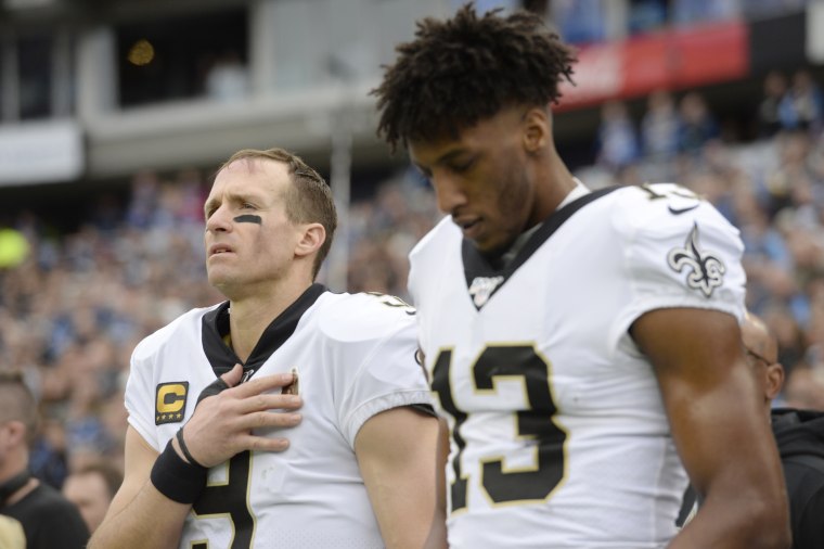 New Orleans Saints quarterback Drew Brees and wide receiver Michael Thomas stand for the national anthem before in Nashville, Tenn., on Dec. 22, 2019.