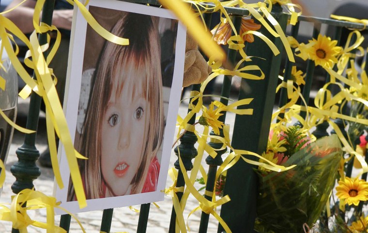 Image: Yellow ribbons, candles and a picture of Madeleine McCann are seen on the railings outside the reception of the Ocean Club in Praia da Luz, Portugal