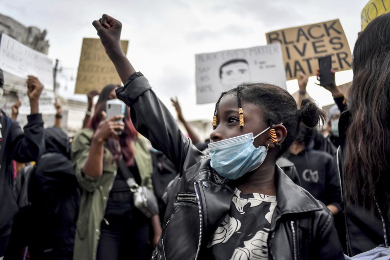 Image: A girl raises her fist during a demonstration against racism in Milan, Italy, on Sunday.