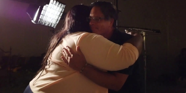 Roxie Washington, who shares a 6-year-old daughter with George Floyd, embraces Don Damond, whose fiancée was shot and killed by a Minneapolis police officer.