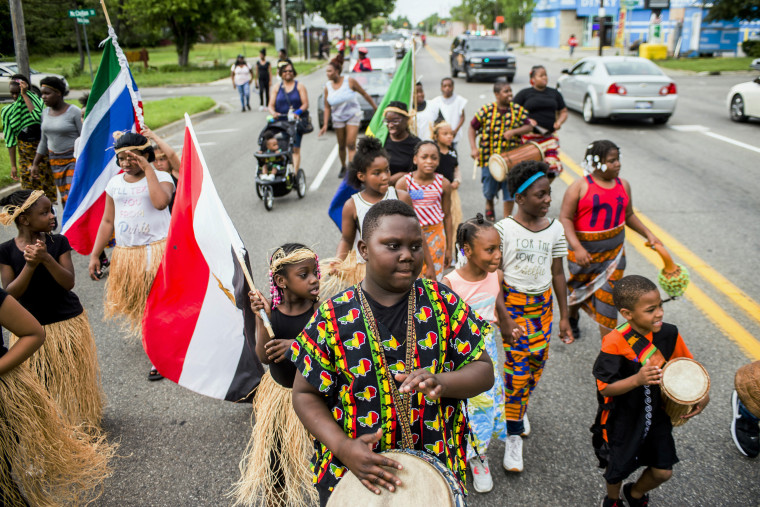 Zebiyan Fields, 11, at center, drums alongside more than 20 kids at the front of the Juneteenth parade in Flint, Michigan on June 19, 2018.